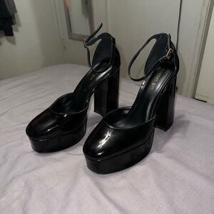 Tall shiny black heels